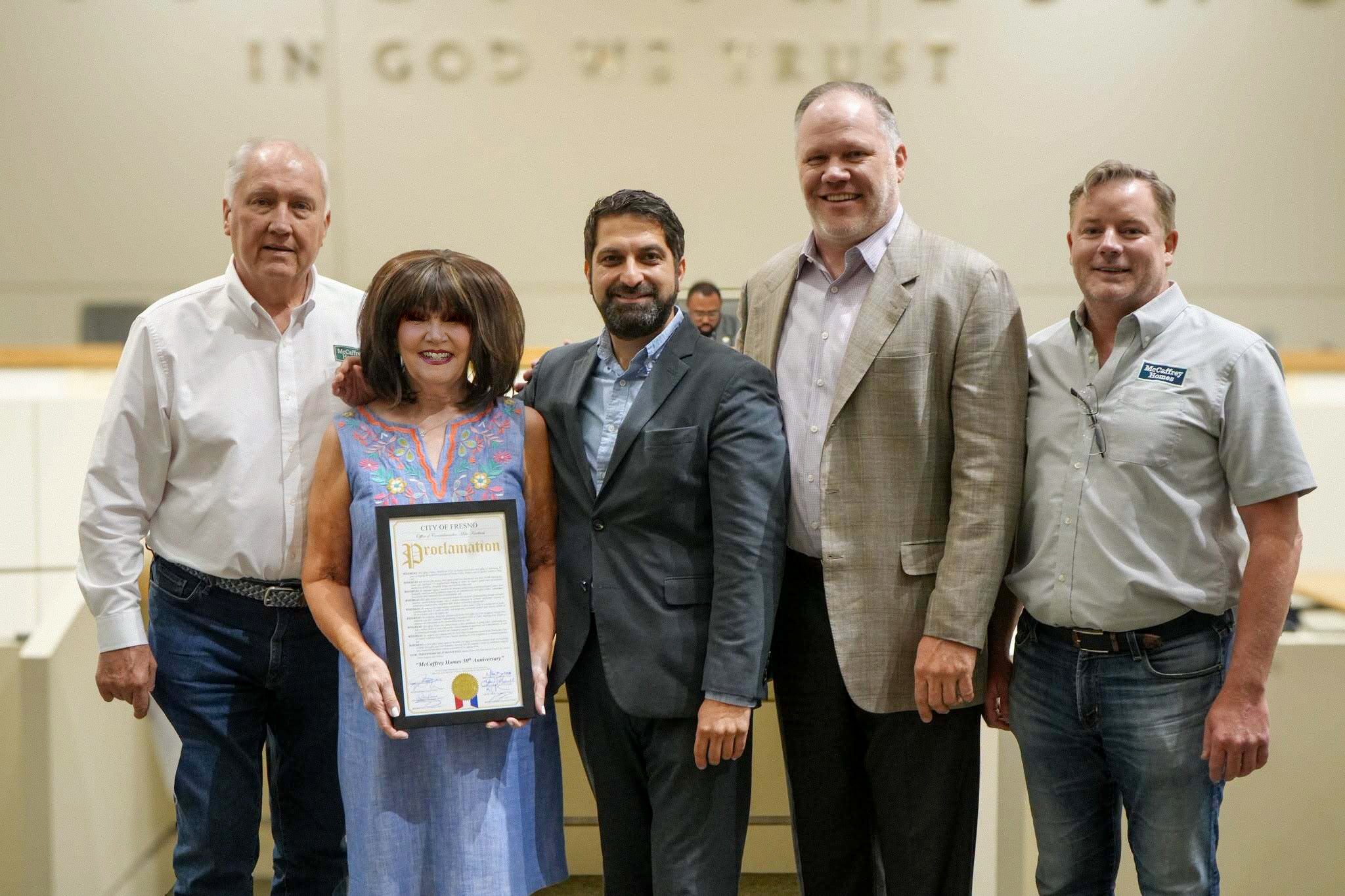 Fresno City Councilperson Mike Karbassi presents a proclamation to Robert and Karen McCaffrey, their son Brent McCaffrey, and son-in-law Ash Knowlton, recognizing McCaffrey Homes’ five decades of home building.