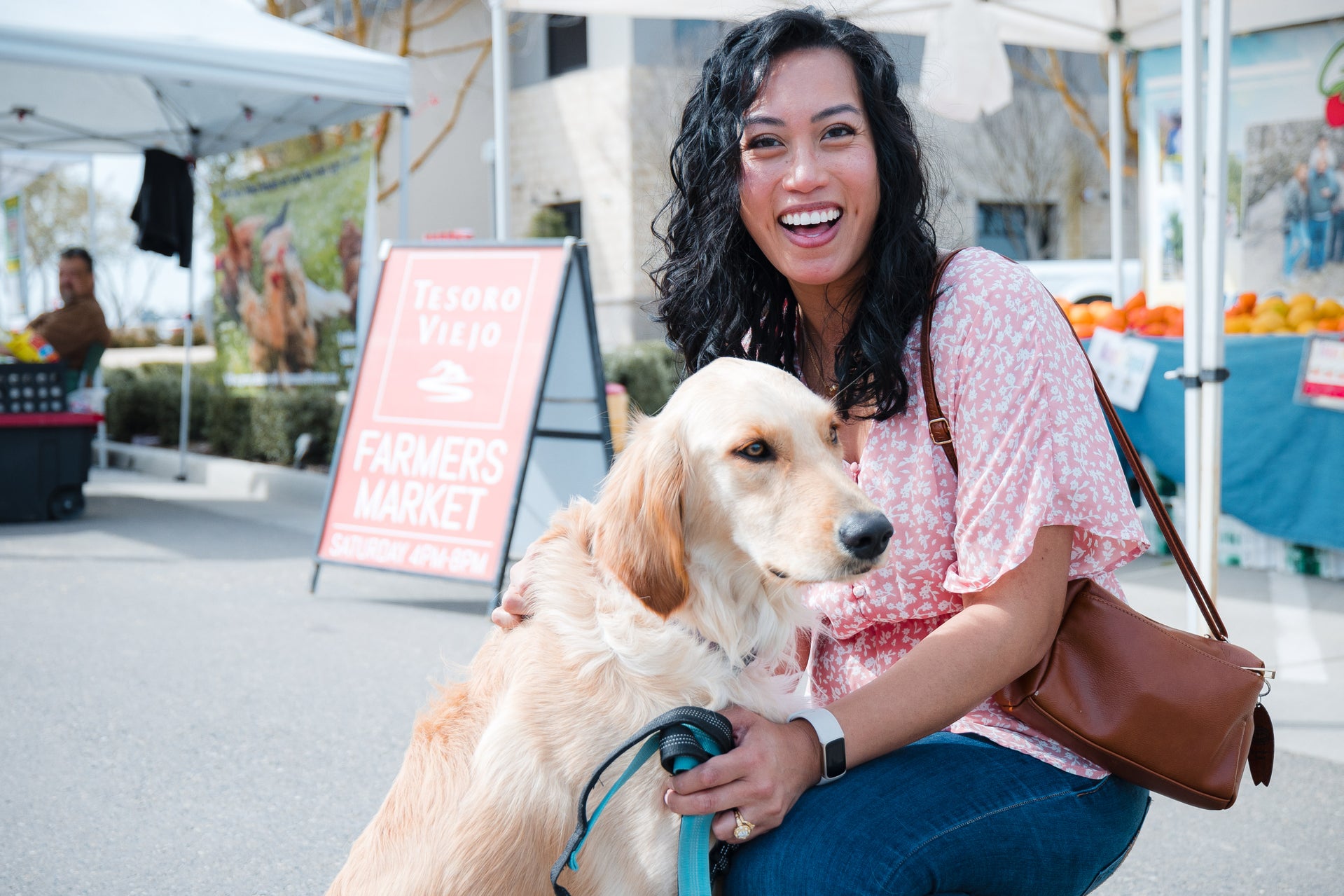 Tesoro Viejo Resident petting dog at weekly farmers Market