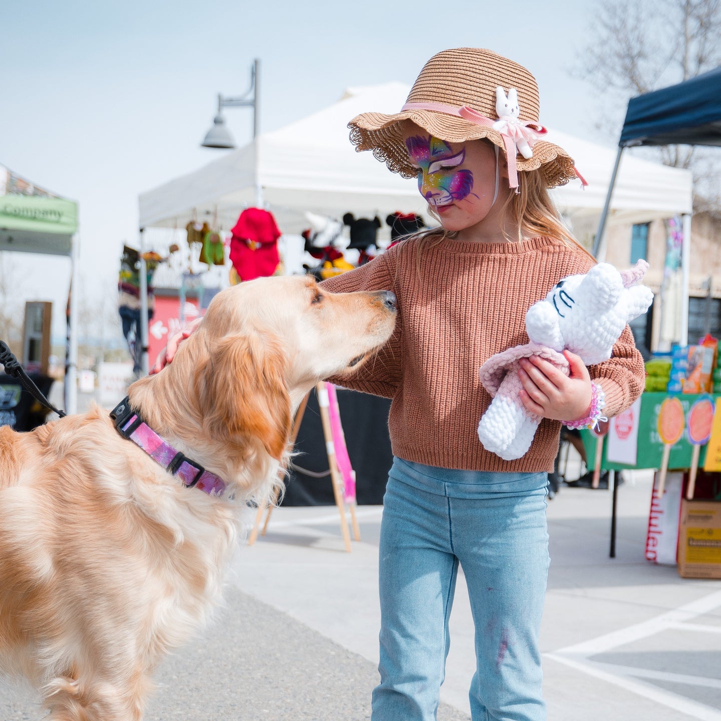 Young girl petting dog at Tesoro Viejo Farmers Market