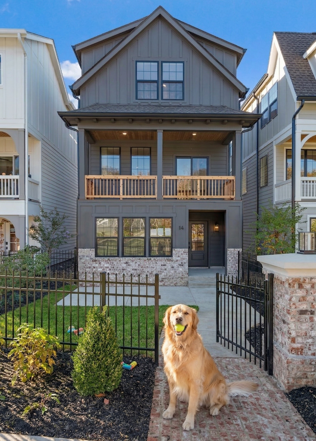 Gated front courtyard with iron fencing and landscaping at Highland Gardens